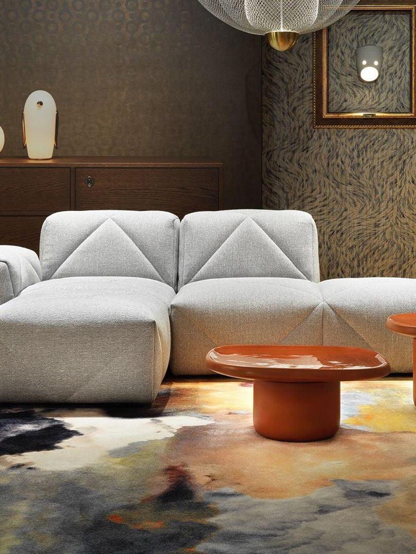 Wide room with white sofa, orange coffee table and distant penguin lamp