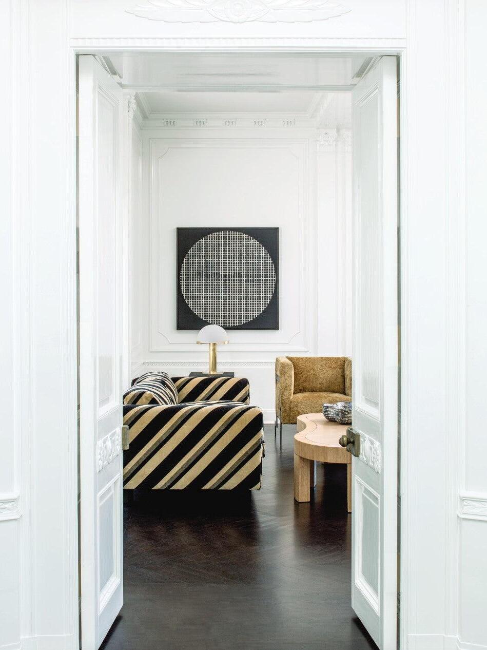 Table lamp glimpsed through a bedroom doorway