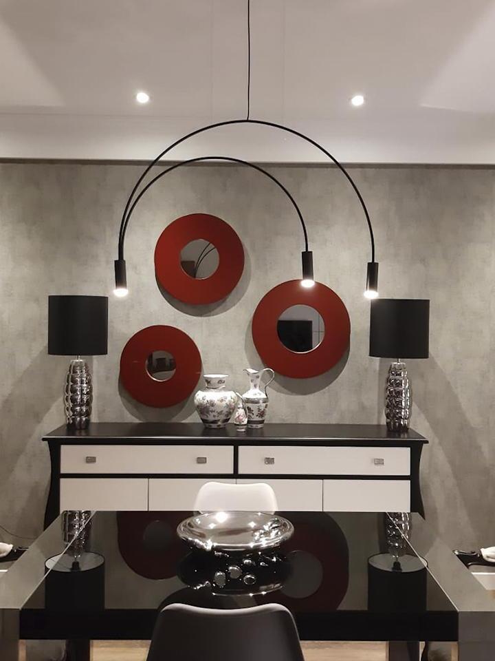 Three-head Black arch pendant above a console
