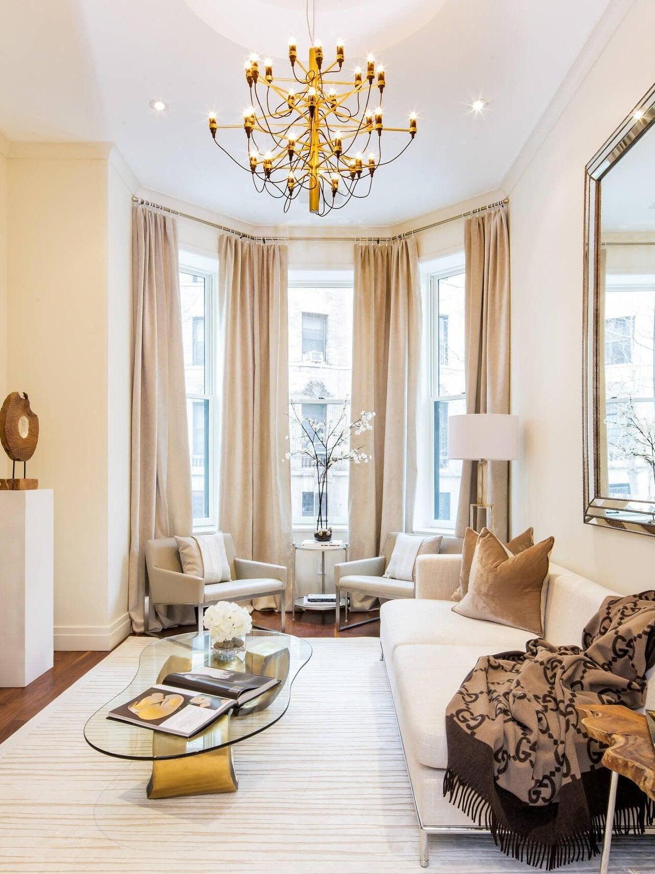 Gold-toned chandelier in a bright living room
