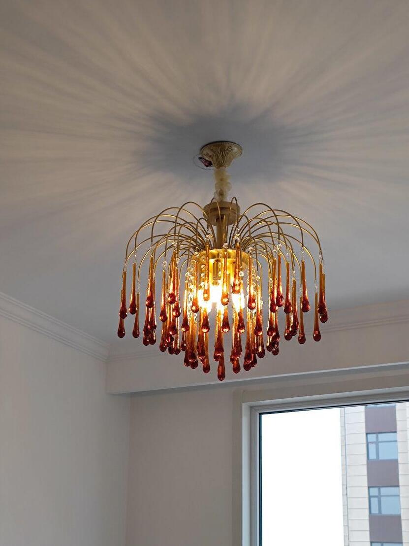 Amber crystal drops throwing light across a ceiling
