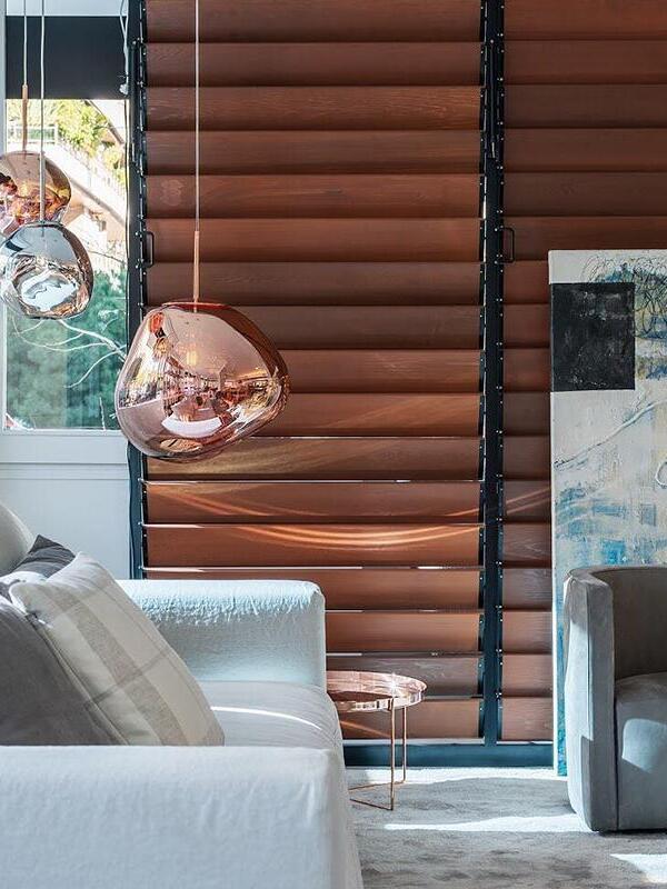 Reflective pendant beside a lounge window