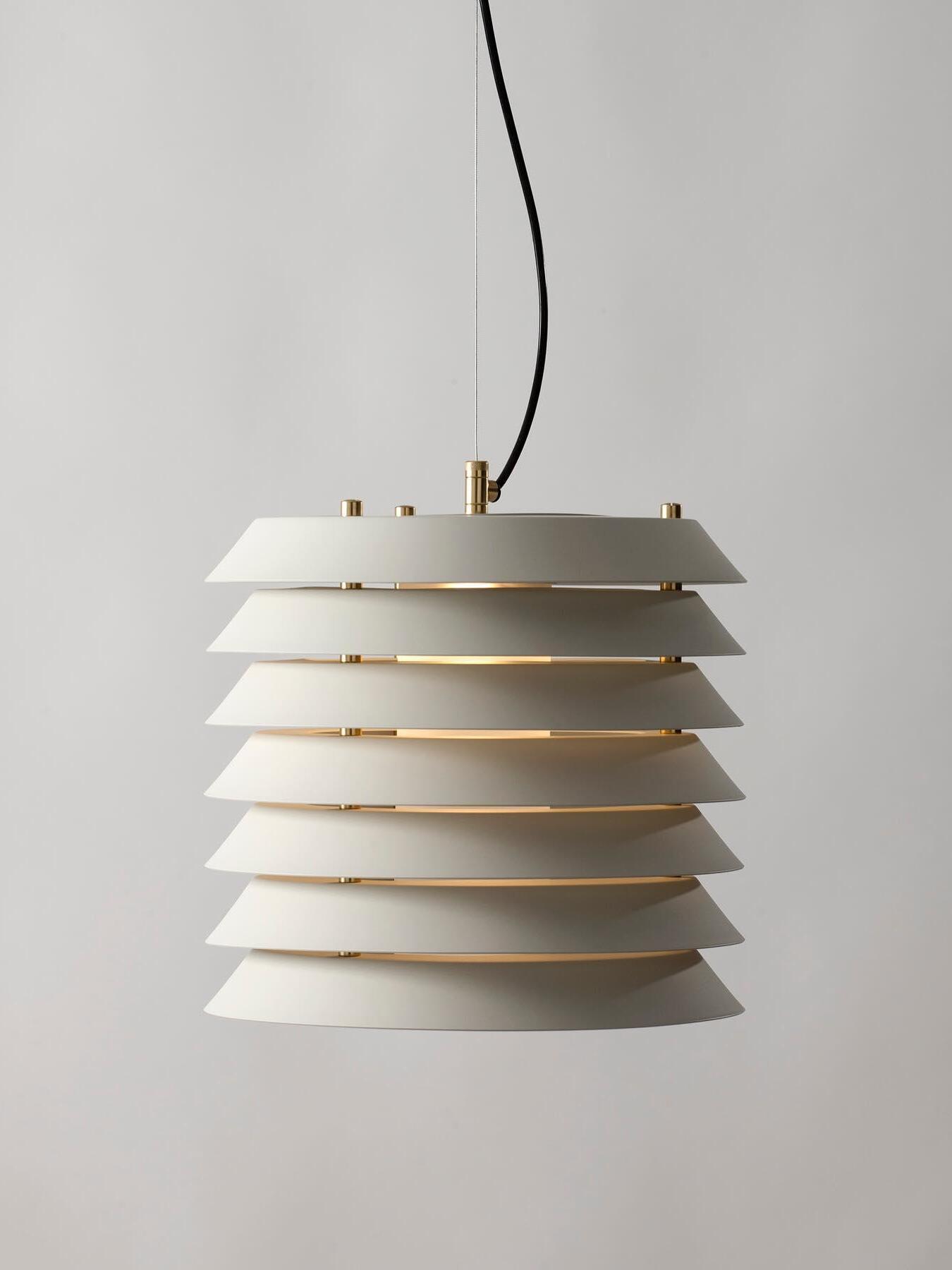 Isolated white flared stacked plates with gold-tone fittings, black cable and thin wire