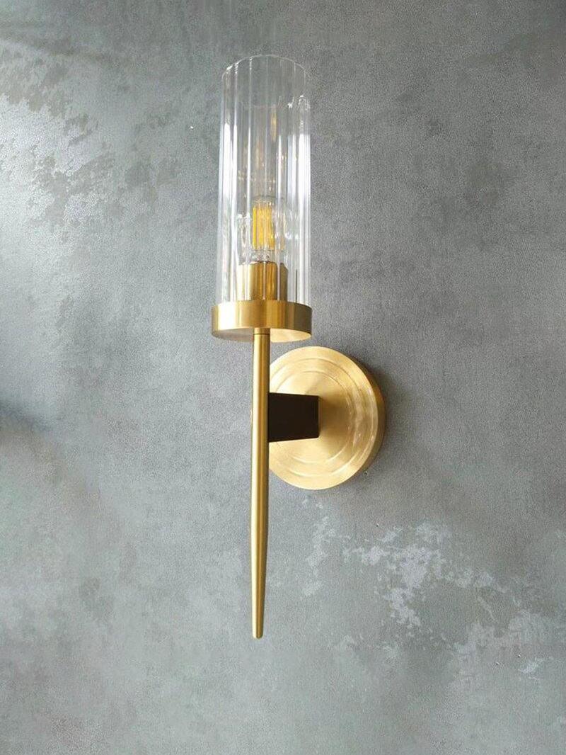 Single wall sconce against a textured grey surface