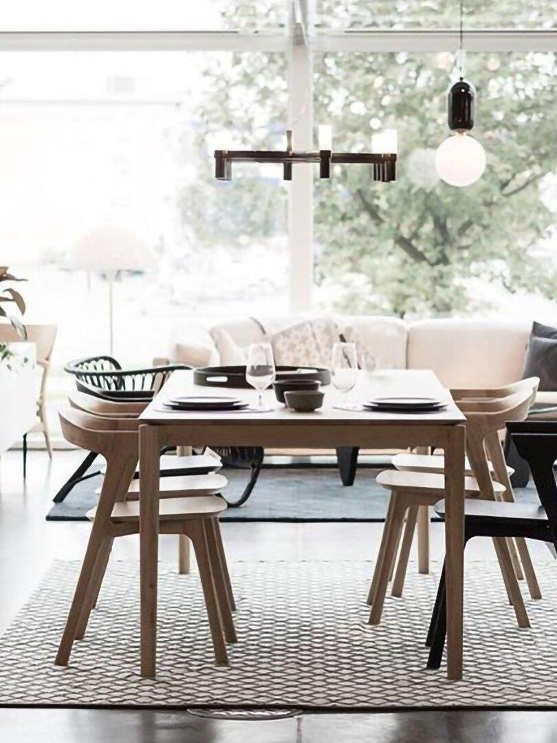 White globe lighting above a pale dining arrangement