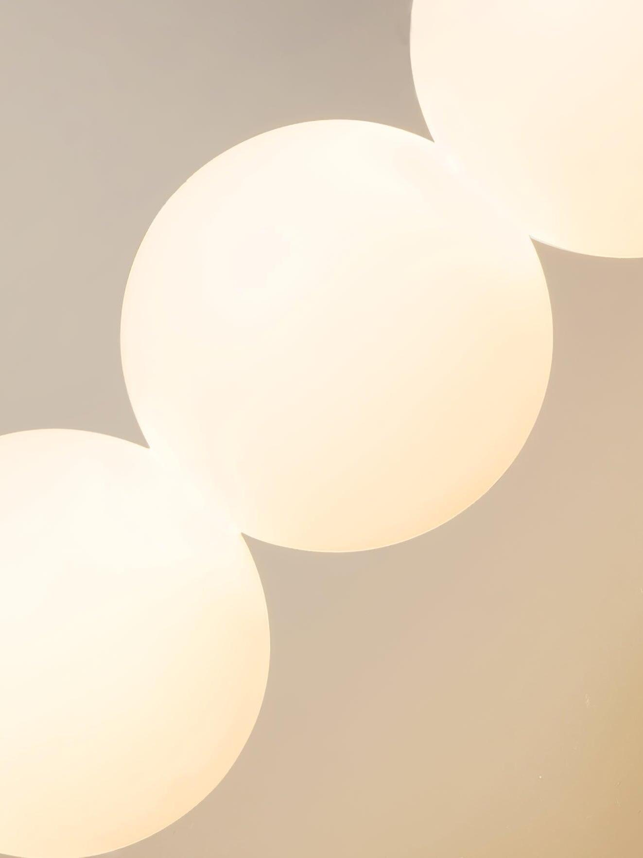 Close view of illuminated white globe-shaped shades