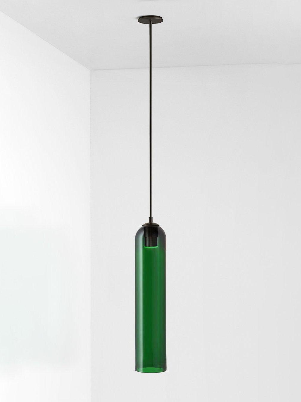 Green glass Long Tube pendant with black straight rod and round black ceiling canopy on pale background