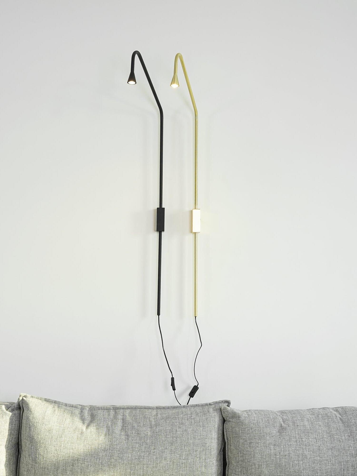 Two long wall sconces with visible cords
