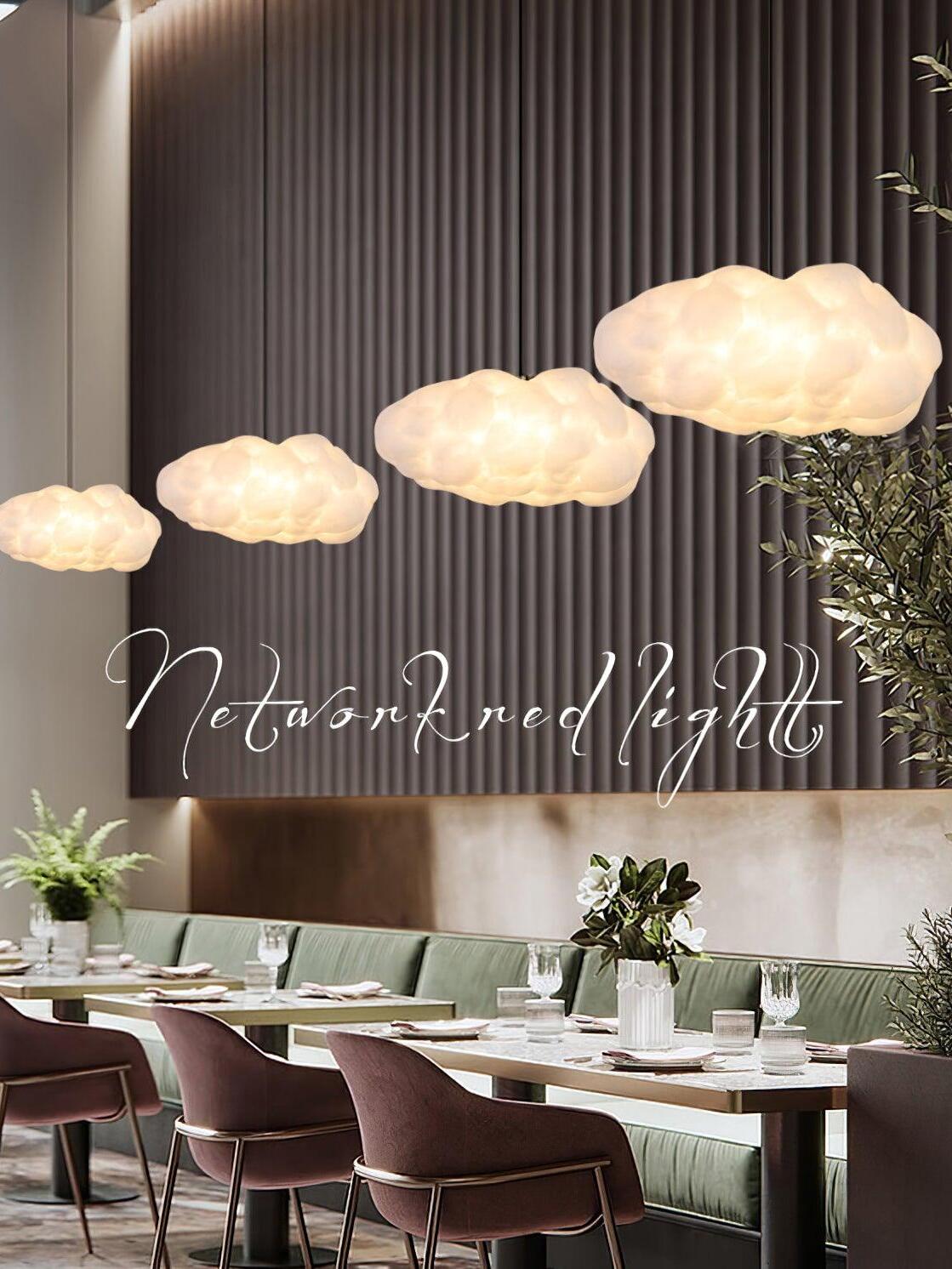 Cloud pendant row above a long table
