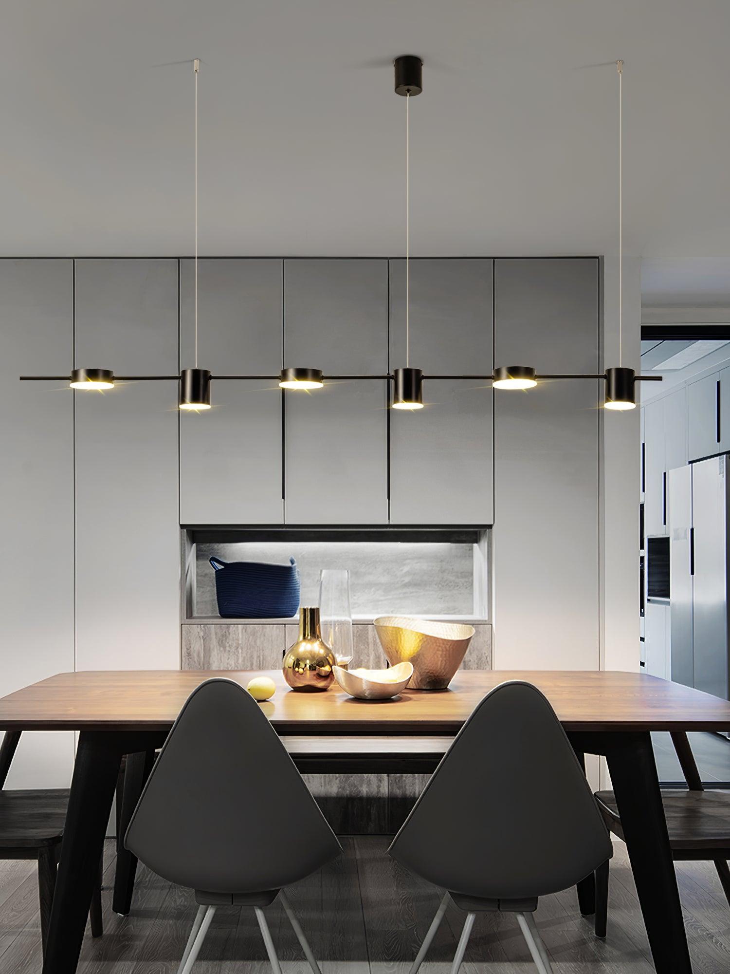 Black linear fixture above a kitchen island and stools