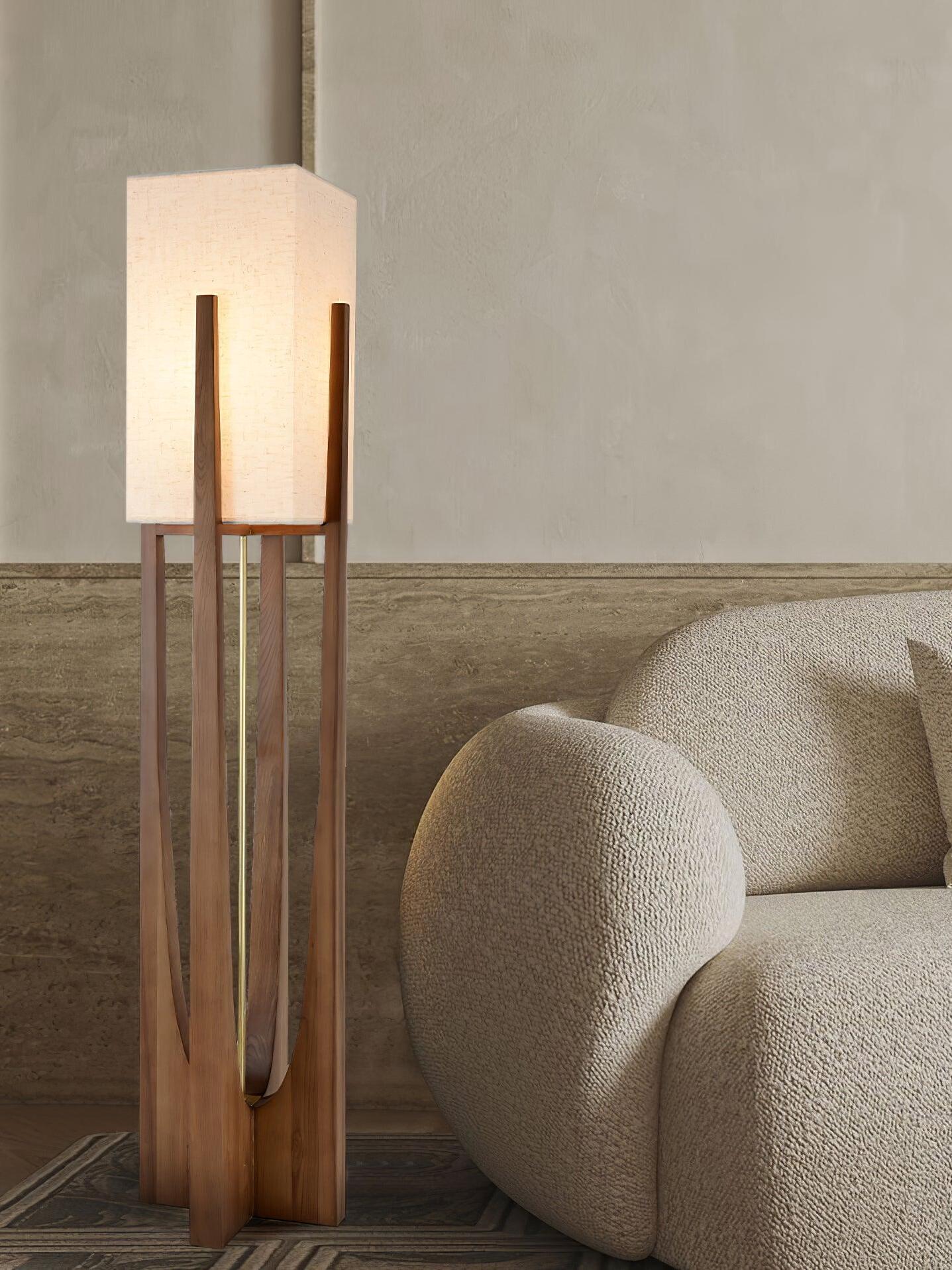 Tall fabric shade lamp beside rounded chair