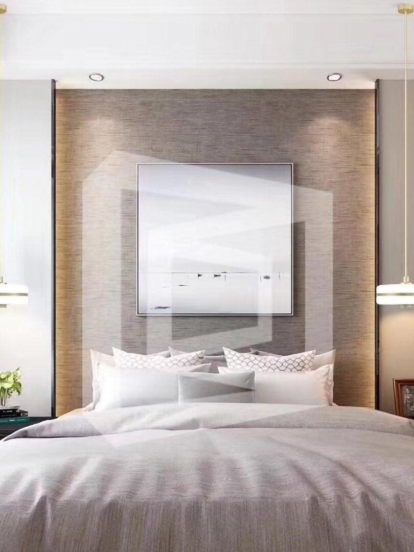 Small hanging lights beside a bed and wall mirror