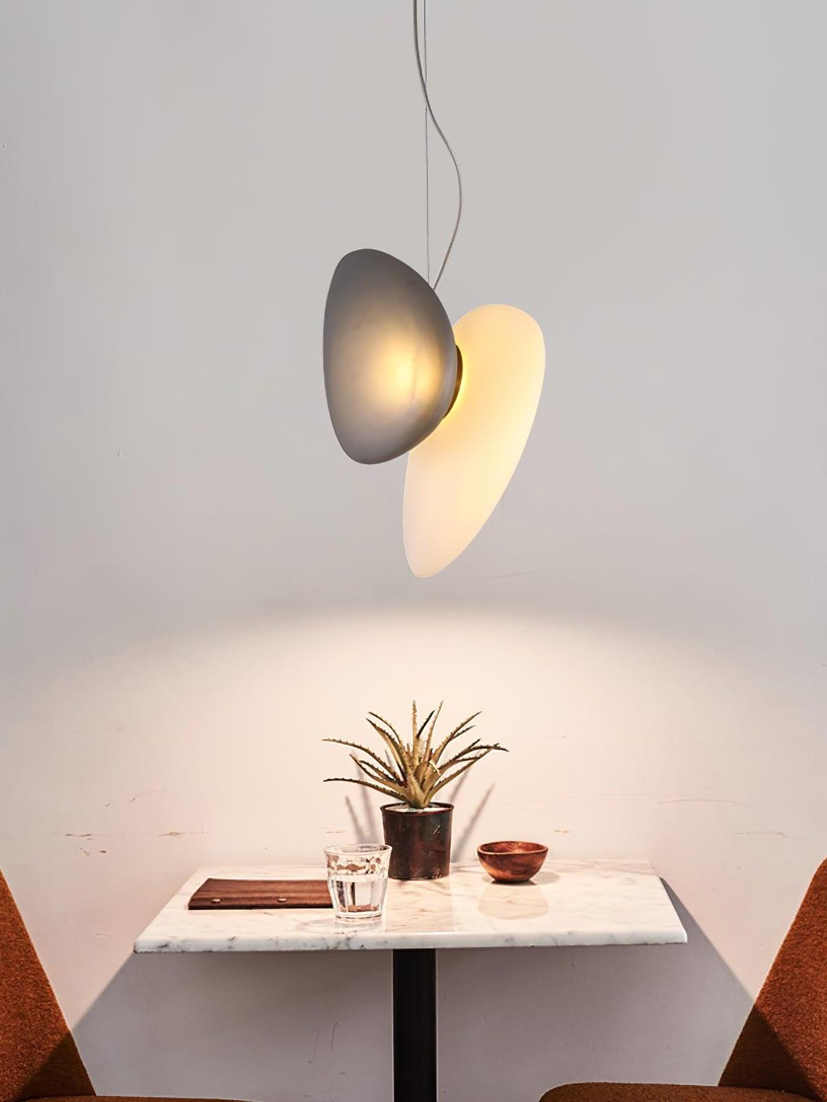 Grey and pale pebble pendant above a small square table