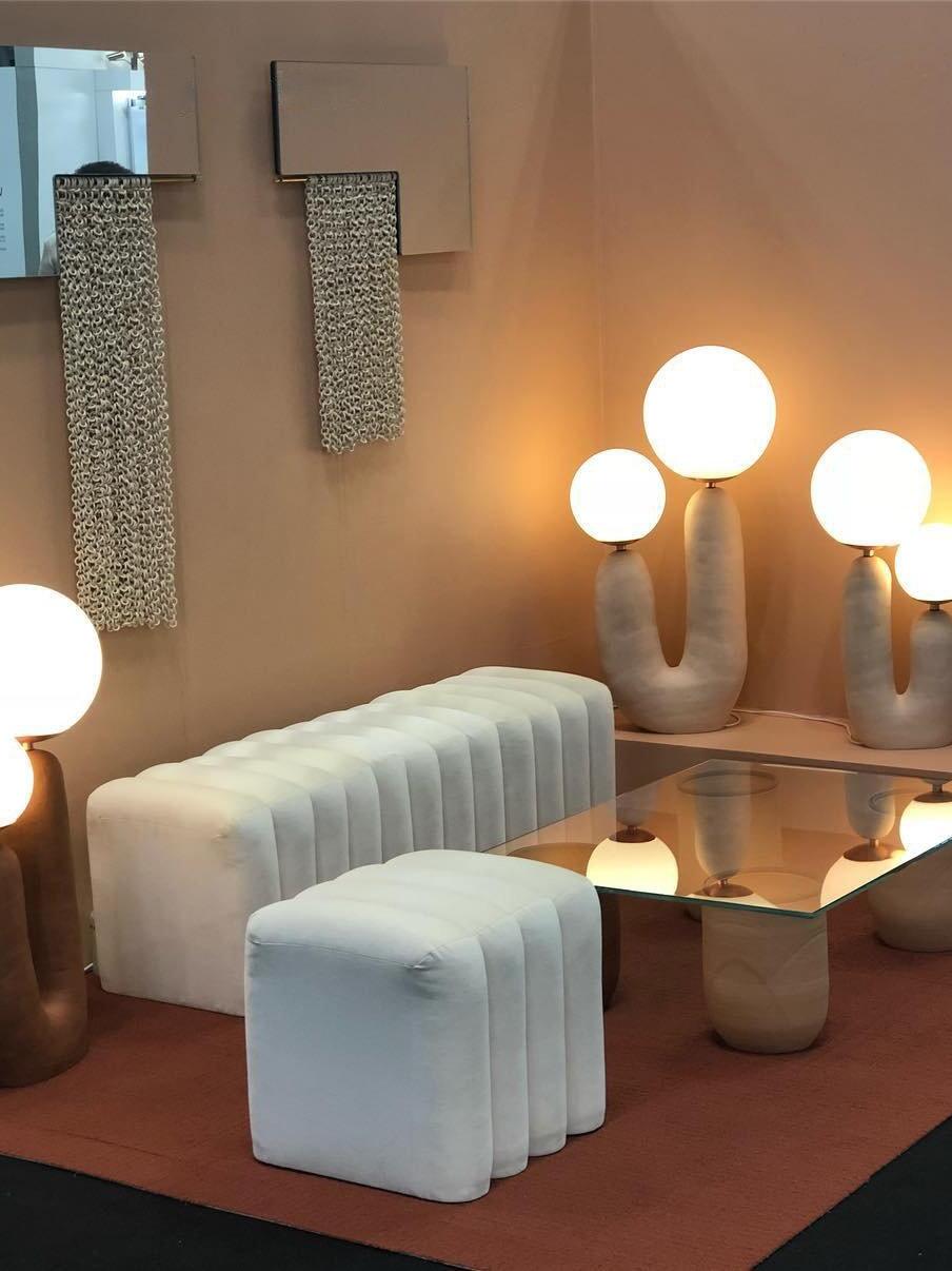 White double-globe lamps in a living-room display