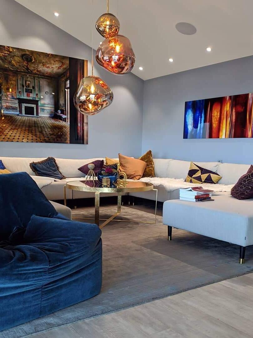 Gold-toned rounded pendants above a seating area