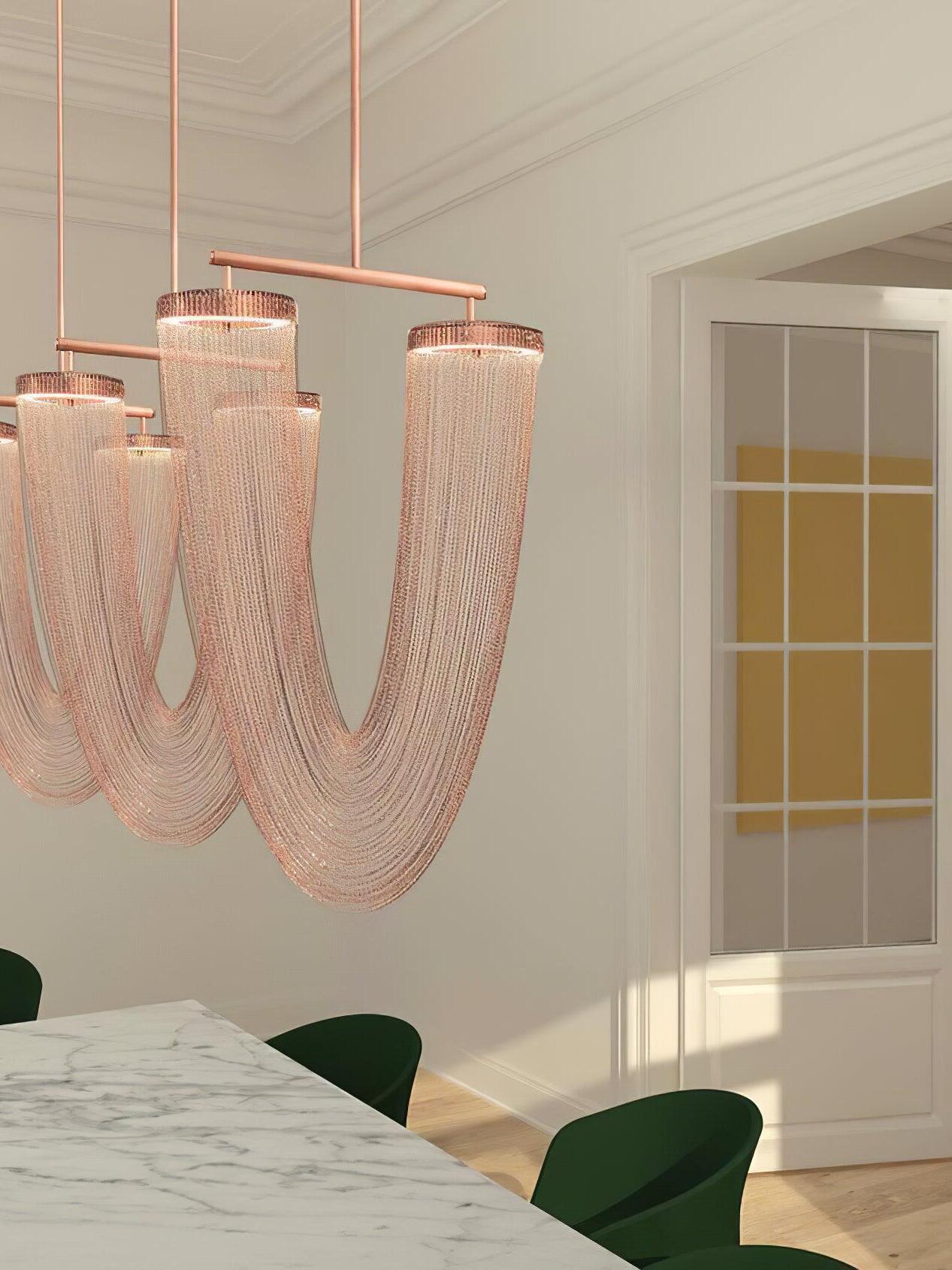 Grouped chain chandeliers above a dining table