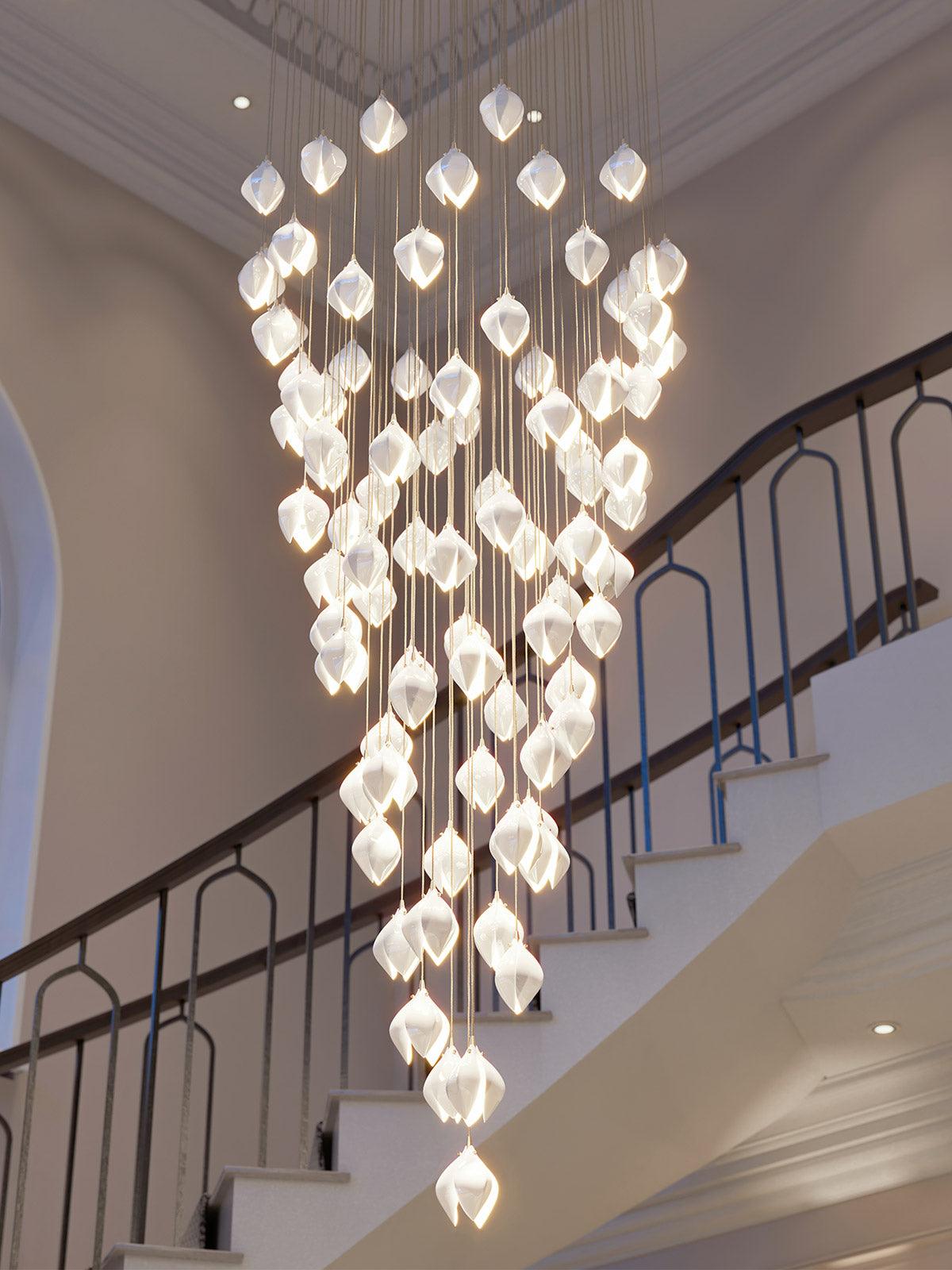 White floral pendants hanging near a staircase