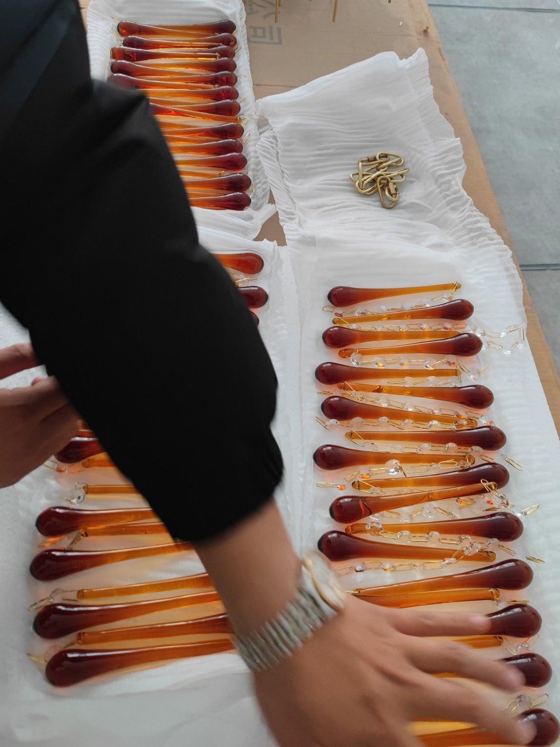 Long amber drops arranged in protective packaging