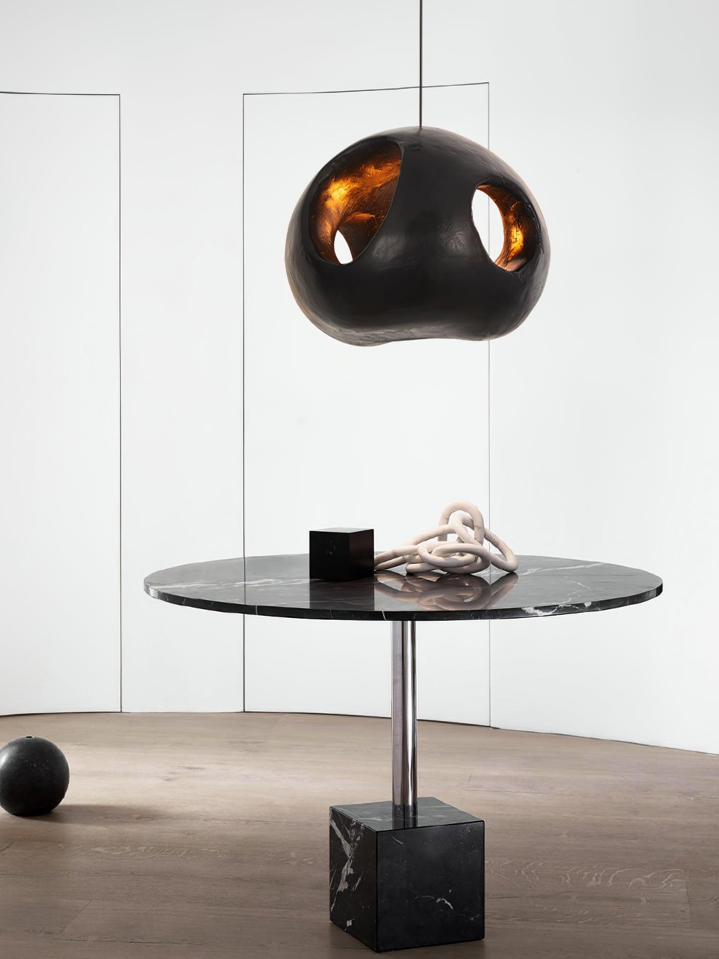 Black open-sided pendant above a small round table