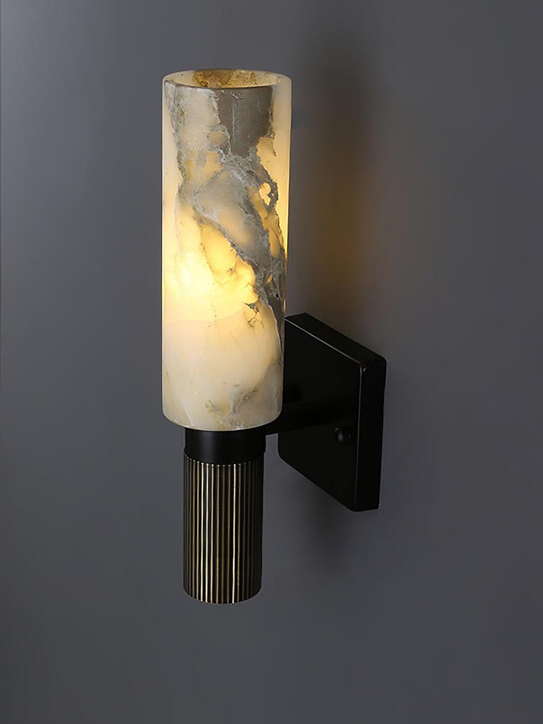 Angled view of marble shade and black wall plate