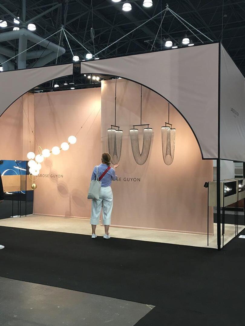 Wide view of a lighting exhibition with chain fixtures