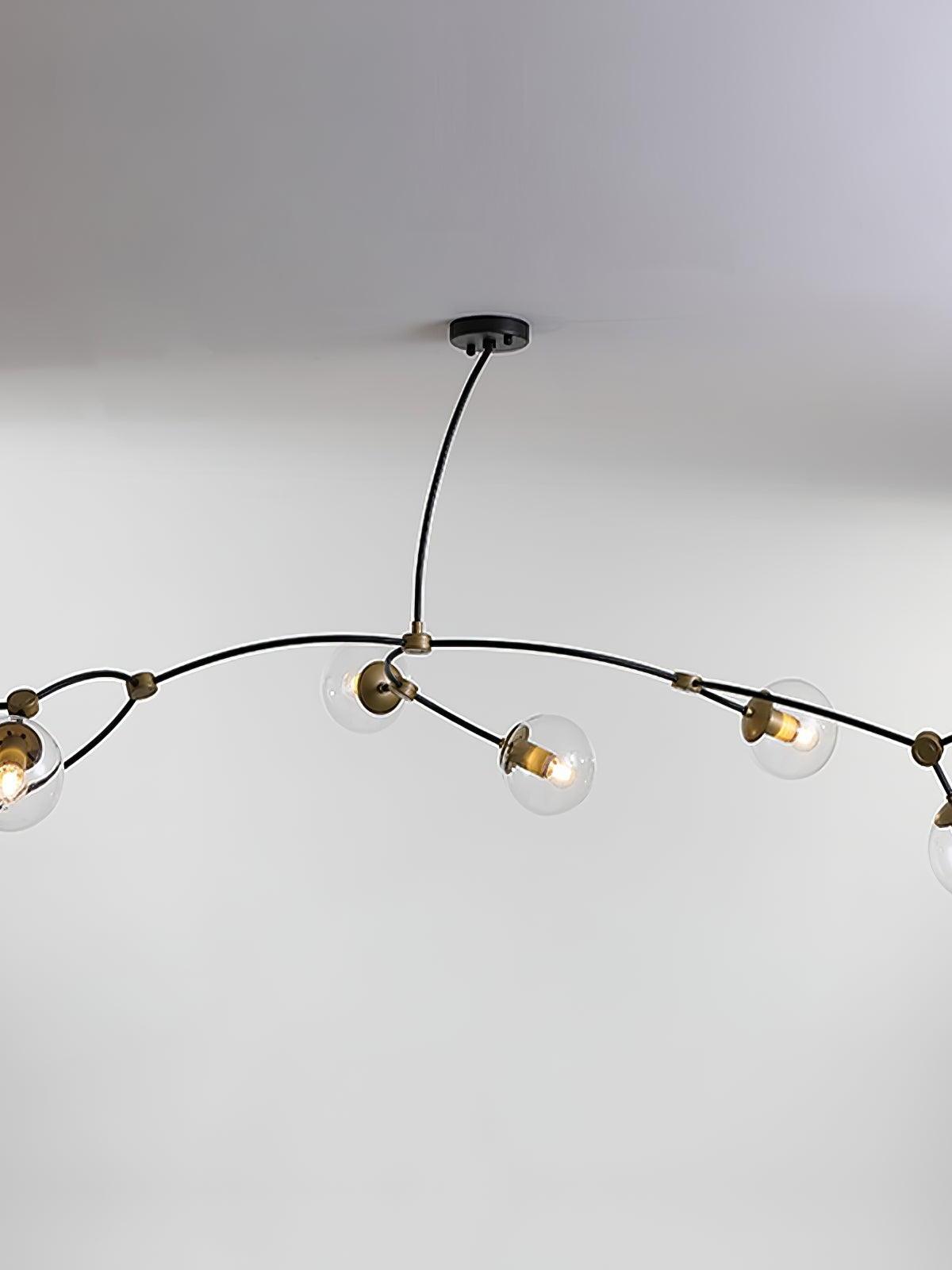 Clear glass globes spread along wide curved black chandelier arms