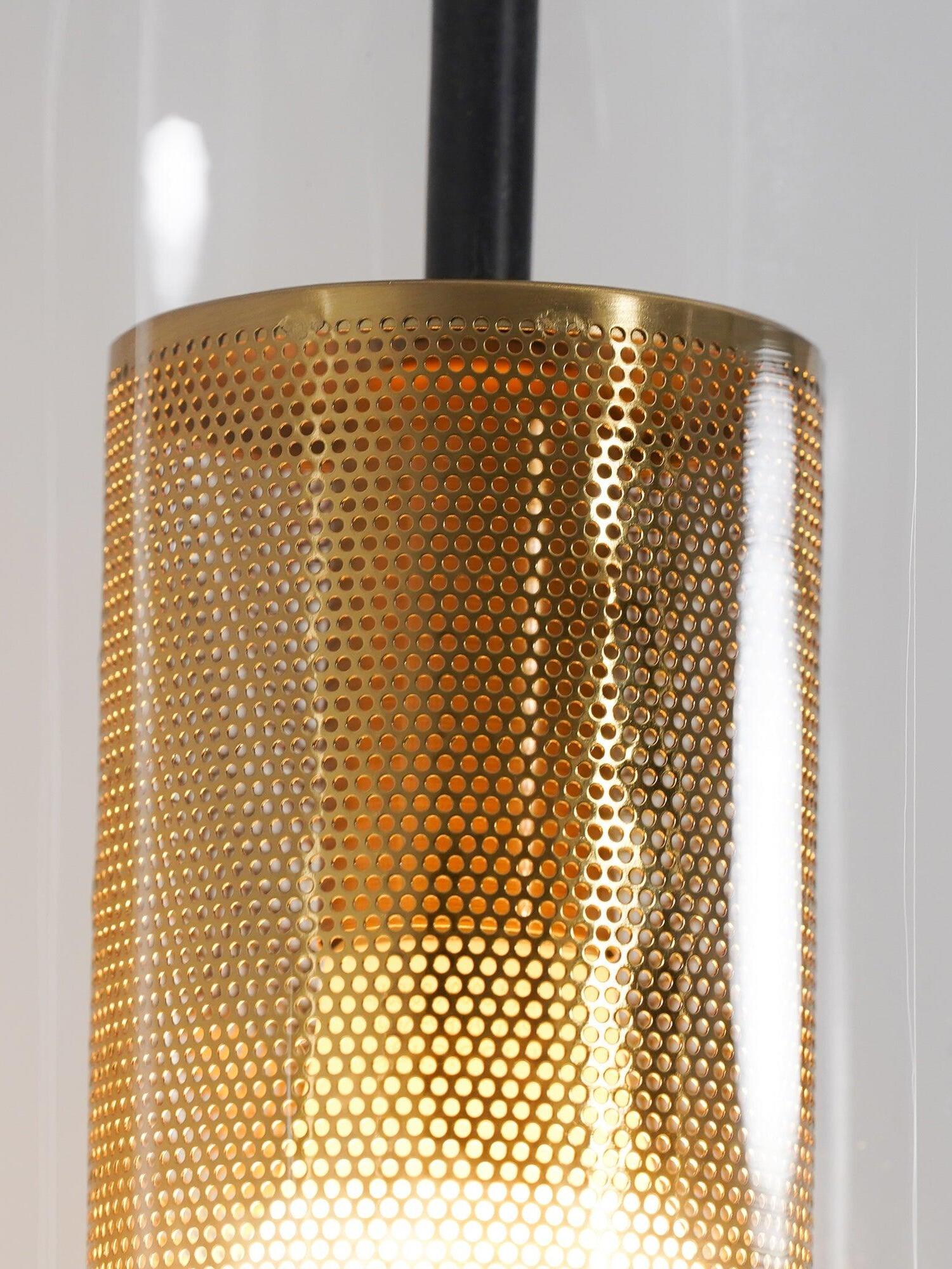 Fine circular holes in a gold-tone cylindrical sleeve with a black rod rising above it