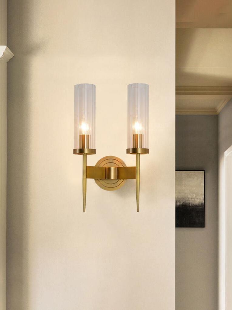 Two-arm glass sconce on a pale paneled wall