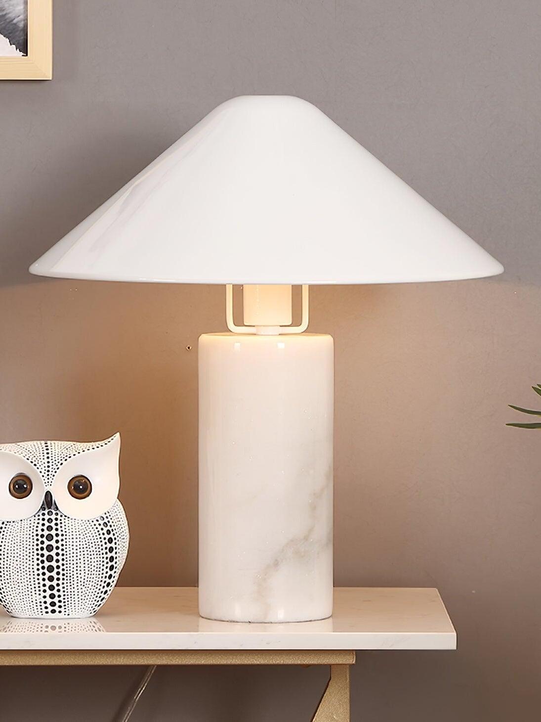 White cone-shade lamp with pale marble cylinder beside ornament