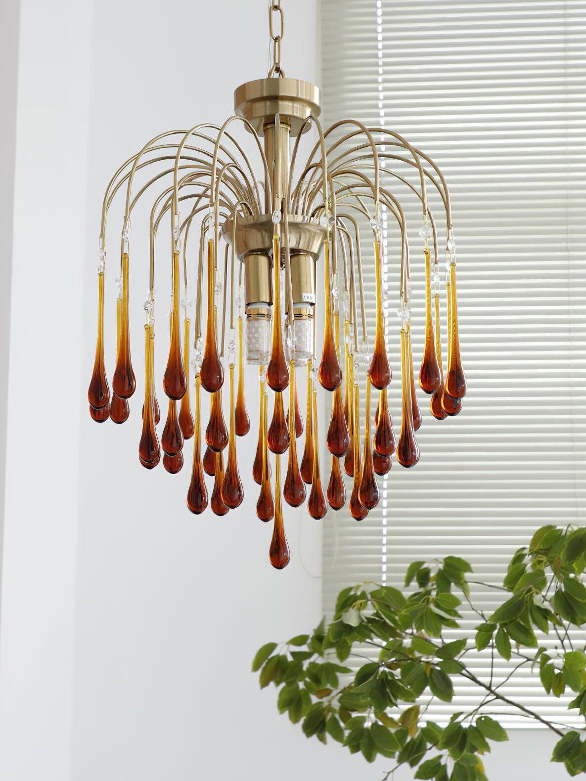 43 cm Caramel chandelier suspended by a chain beside window blinds