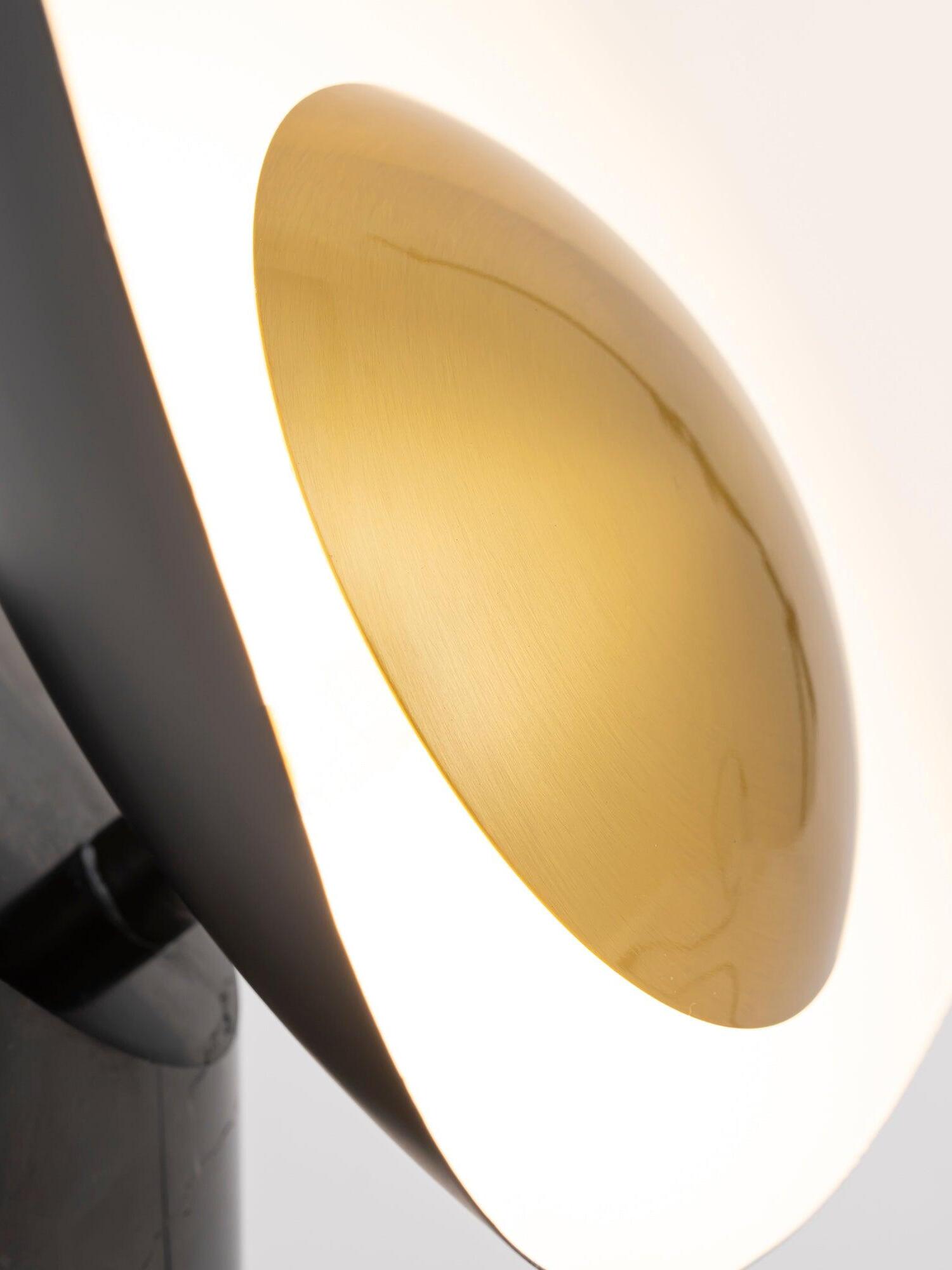 Close gold-tone disc and glowing white surround