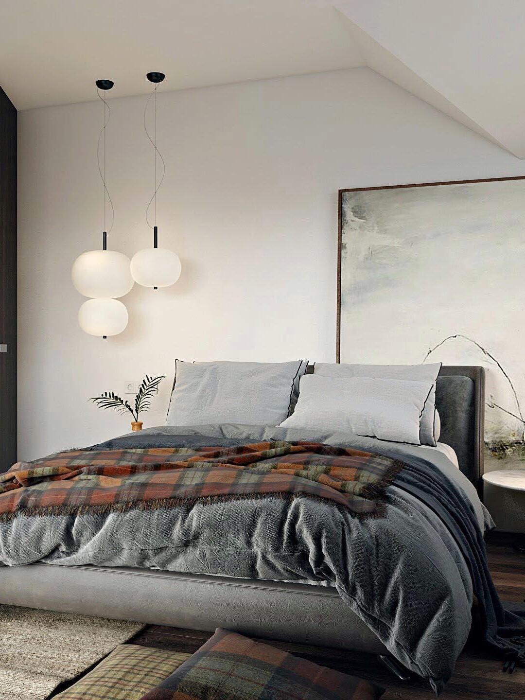 Multiple globe pendants shown beside a bed