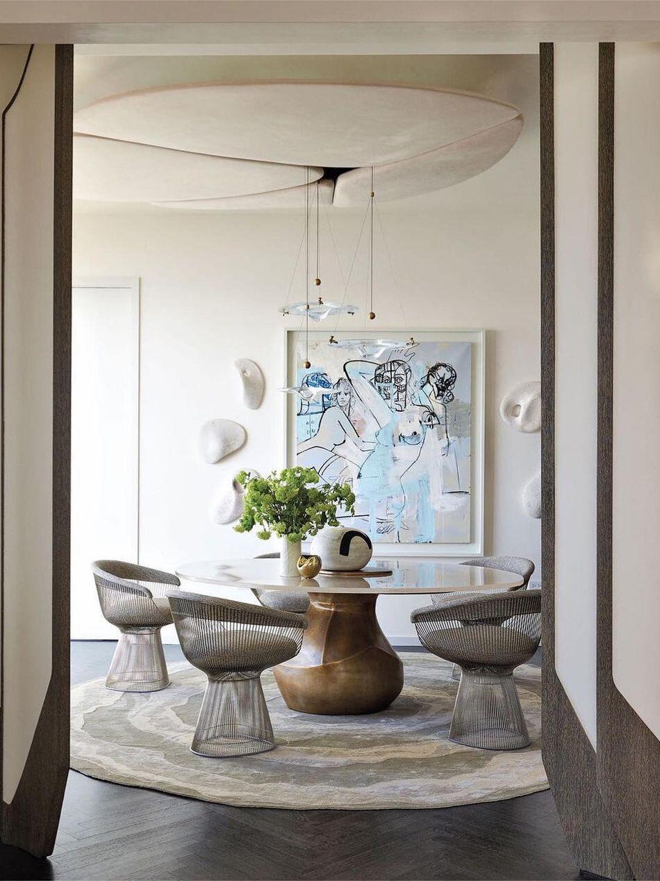 Glass disc pendant group over round dining table