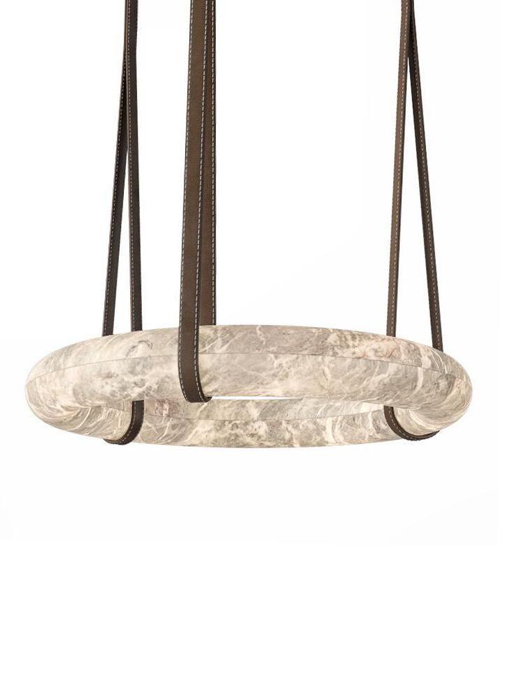 Horizontal white alabaster ring suspended from dark brown straps
