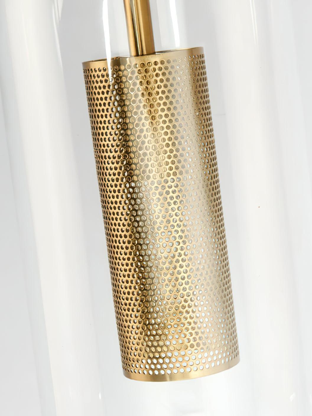 Unlit gold-tone perforated cylinder visible through the clear rounded glass shade