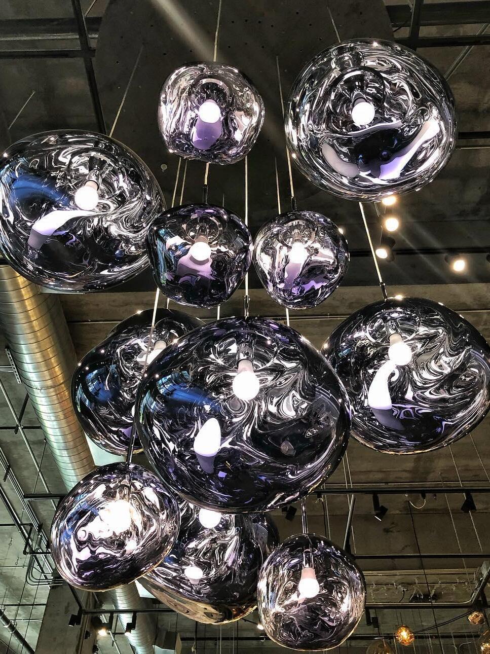 Dark sculptural pendants at varied heights