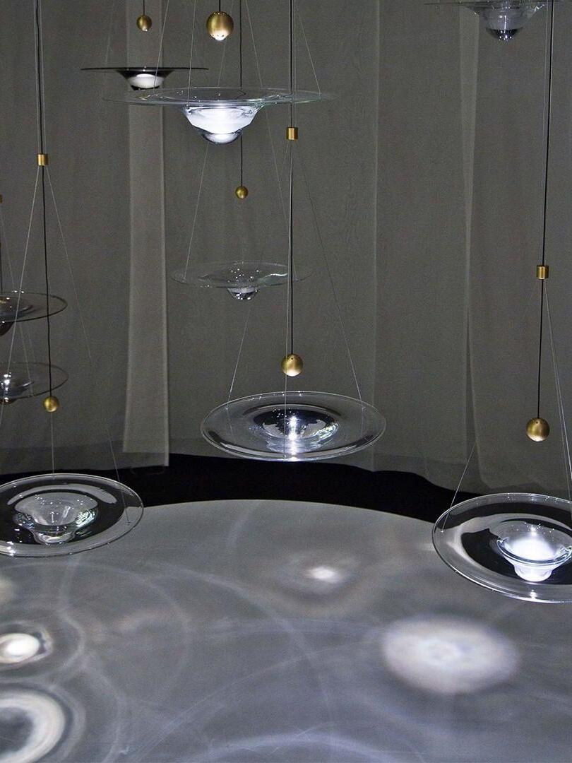 Glass disc pendants hanging above patterned floor