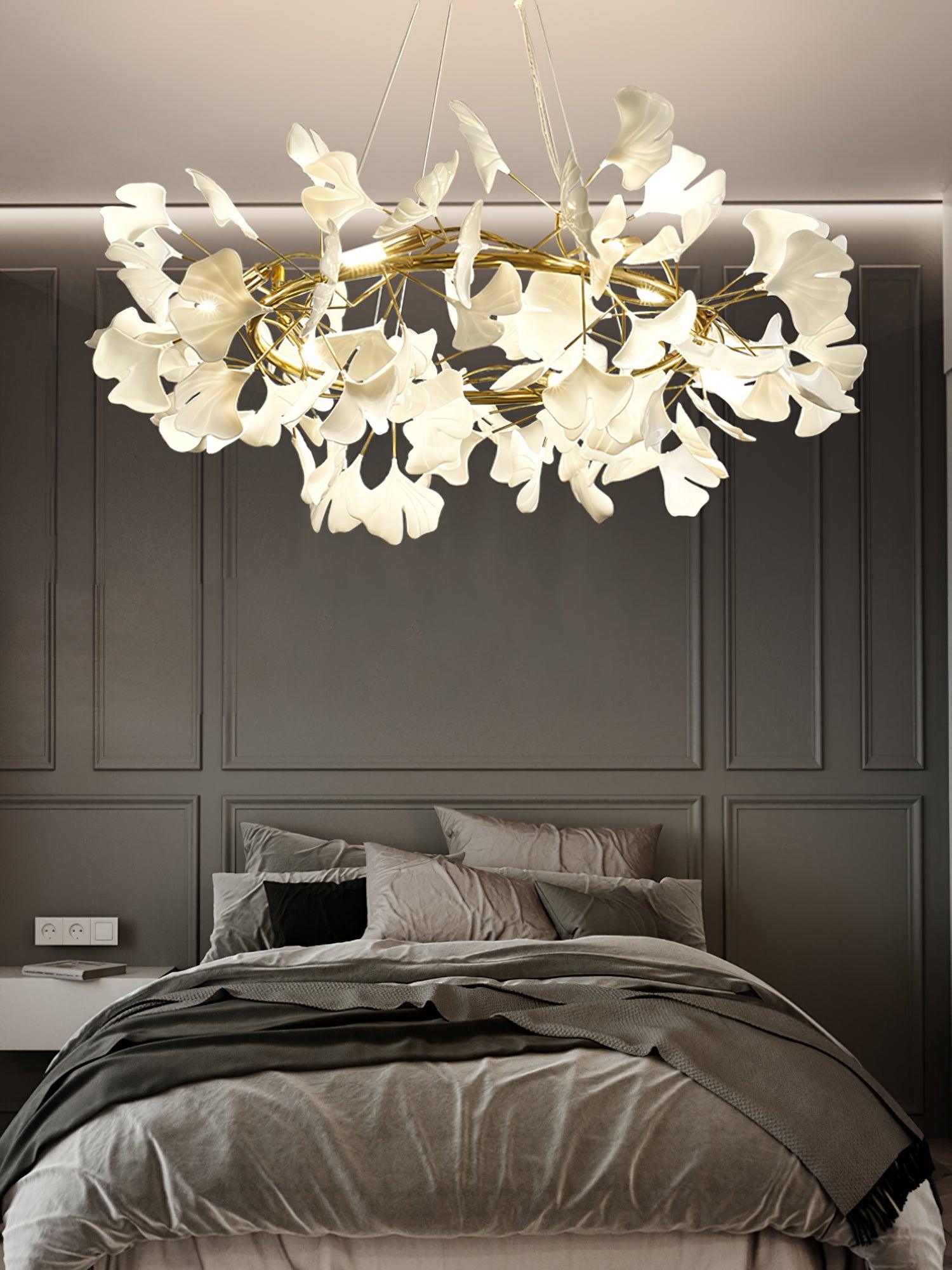 Gingko O white leaf chandelier above a bed