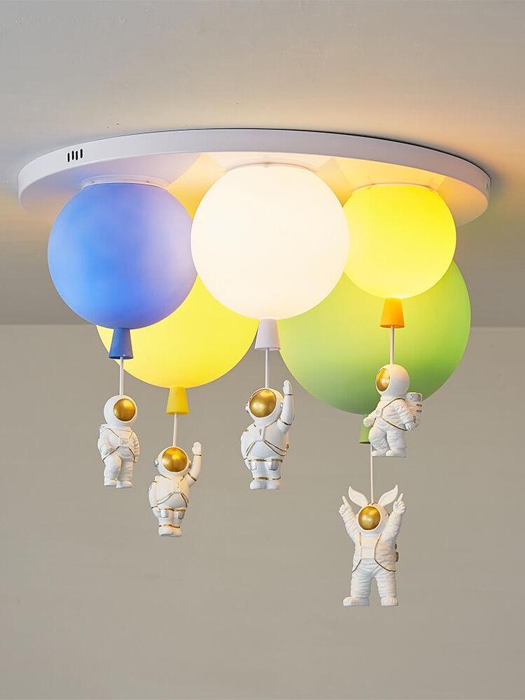 Five coloured balloon shades illuminated beneath a round plate