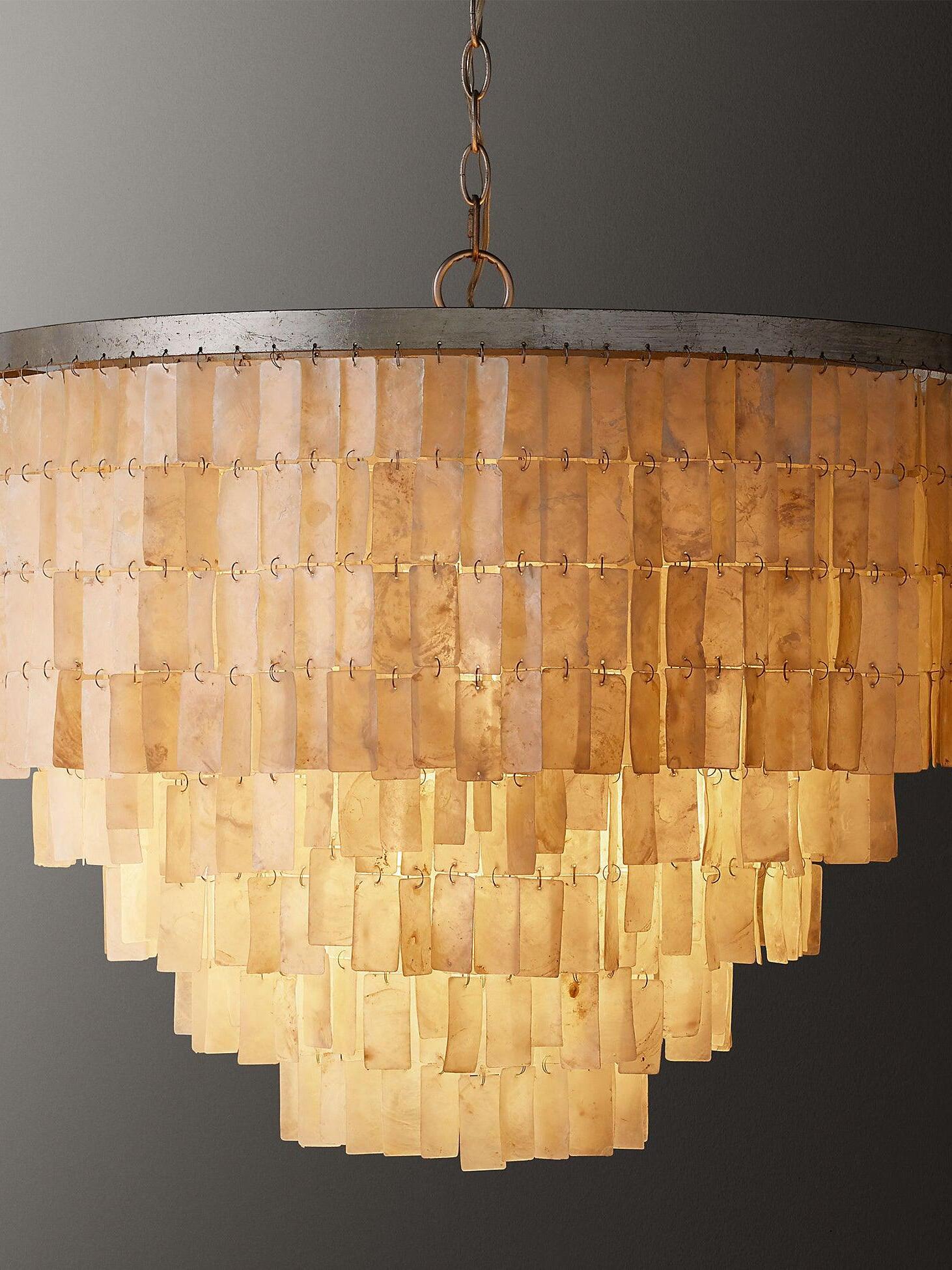 Illuminated shell pendant against a dark background