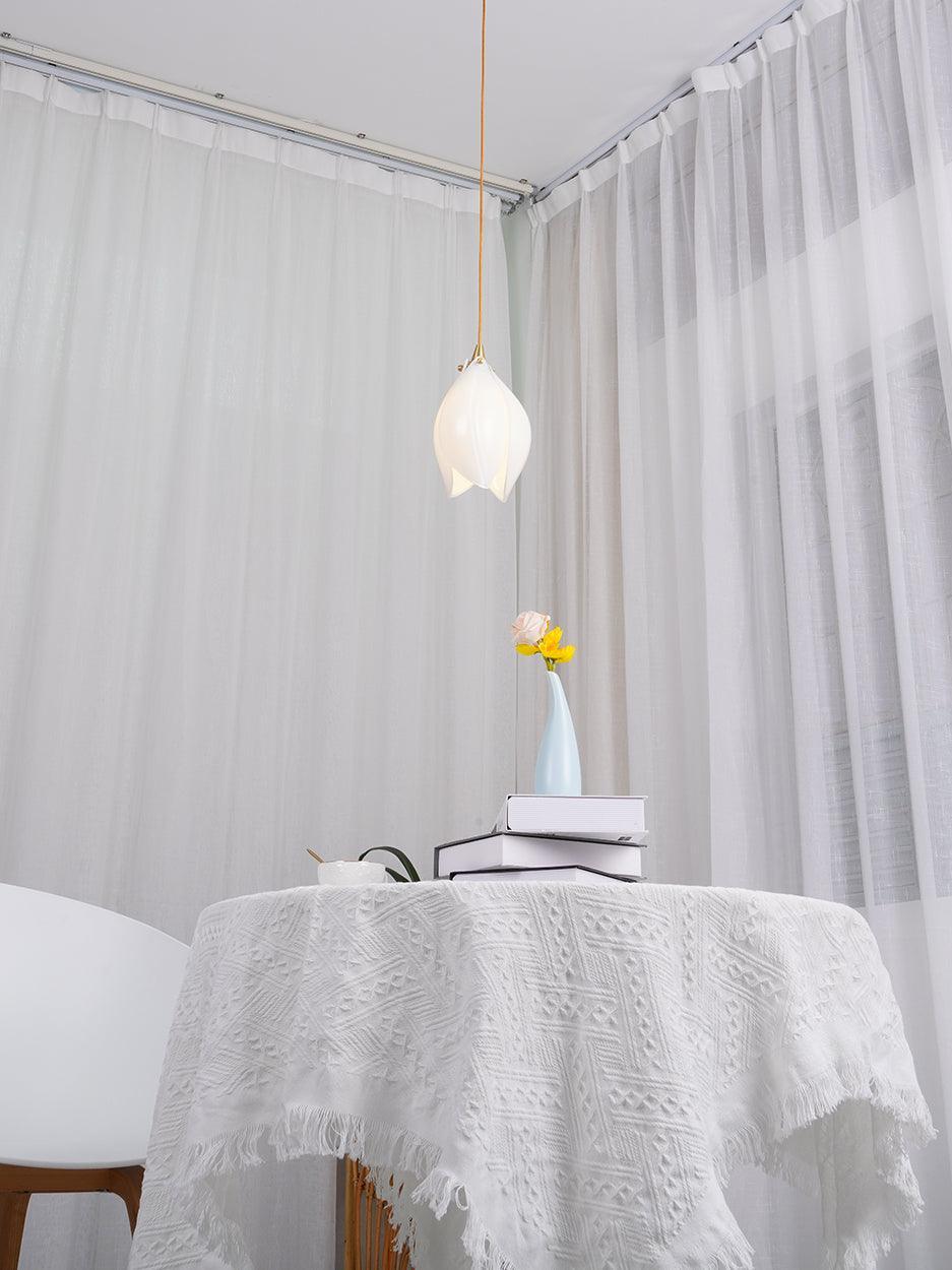 Single White pendant over a cloth-covered table