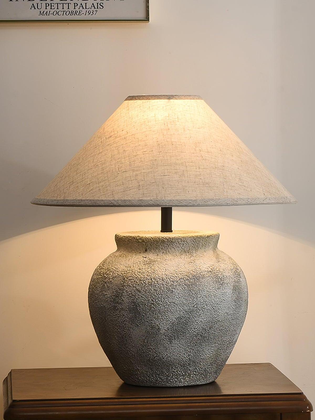 Warm-lit lamp with darker-looking mottled urn base