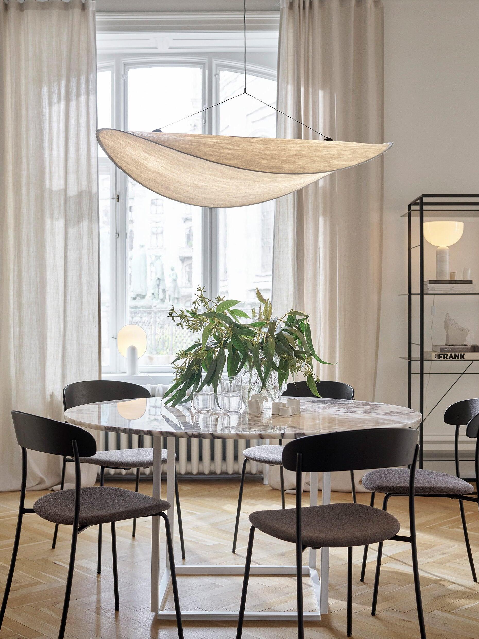 Tense above a round table and plant