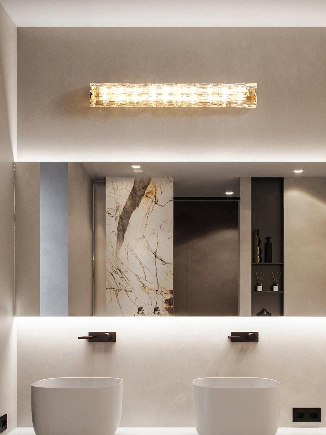 Horizontal glass light above bathroom mirror and twin basins