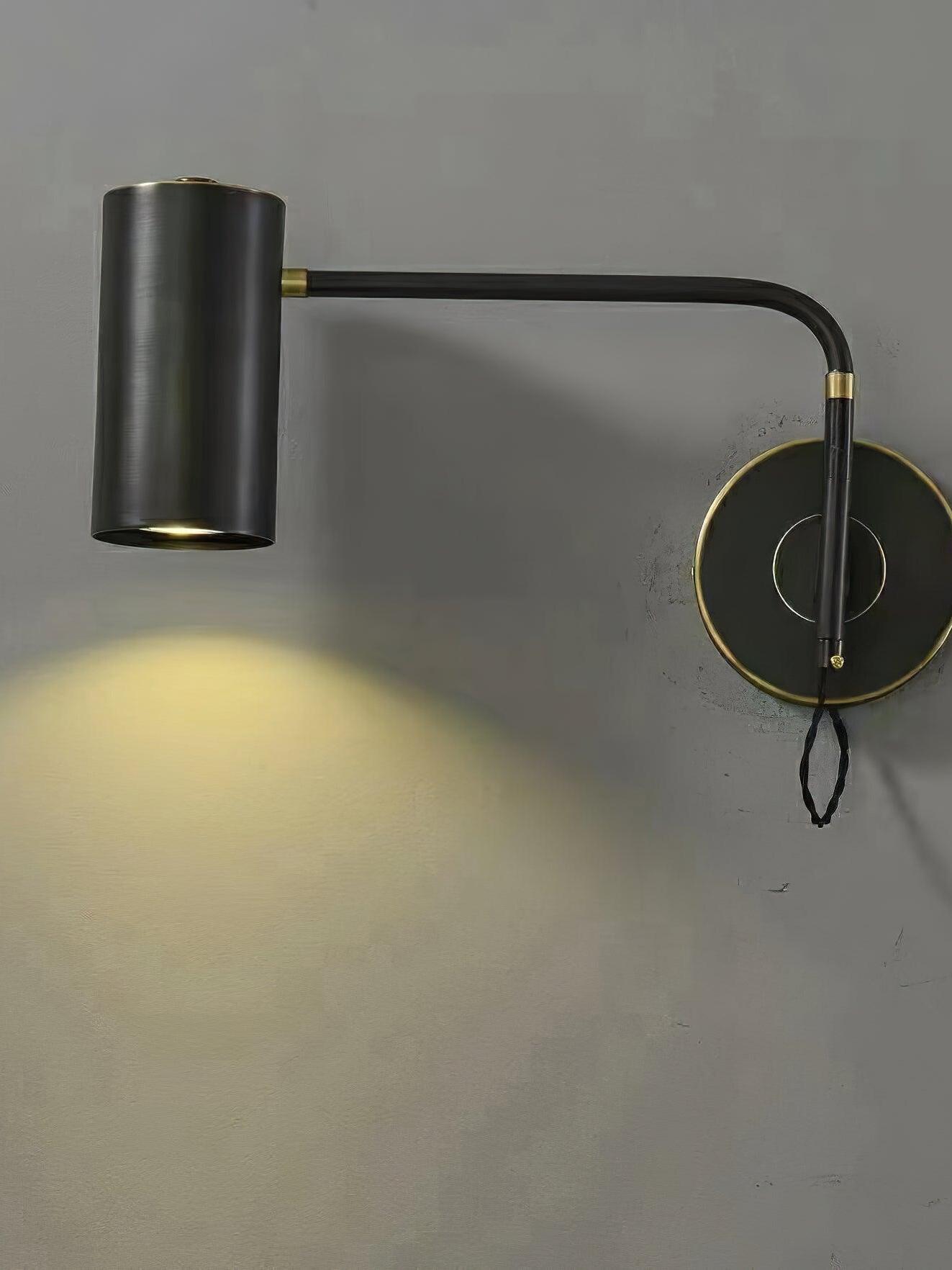 Extended black-and-gold wall light casting light downward