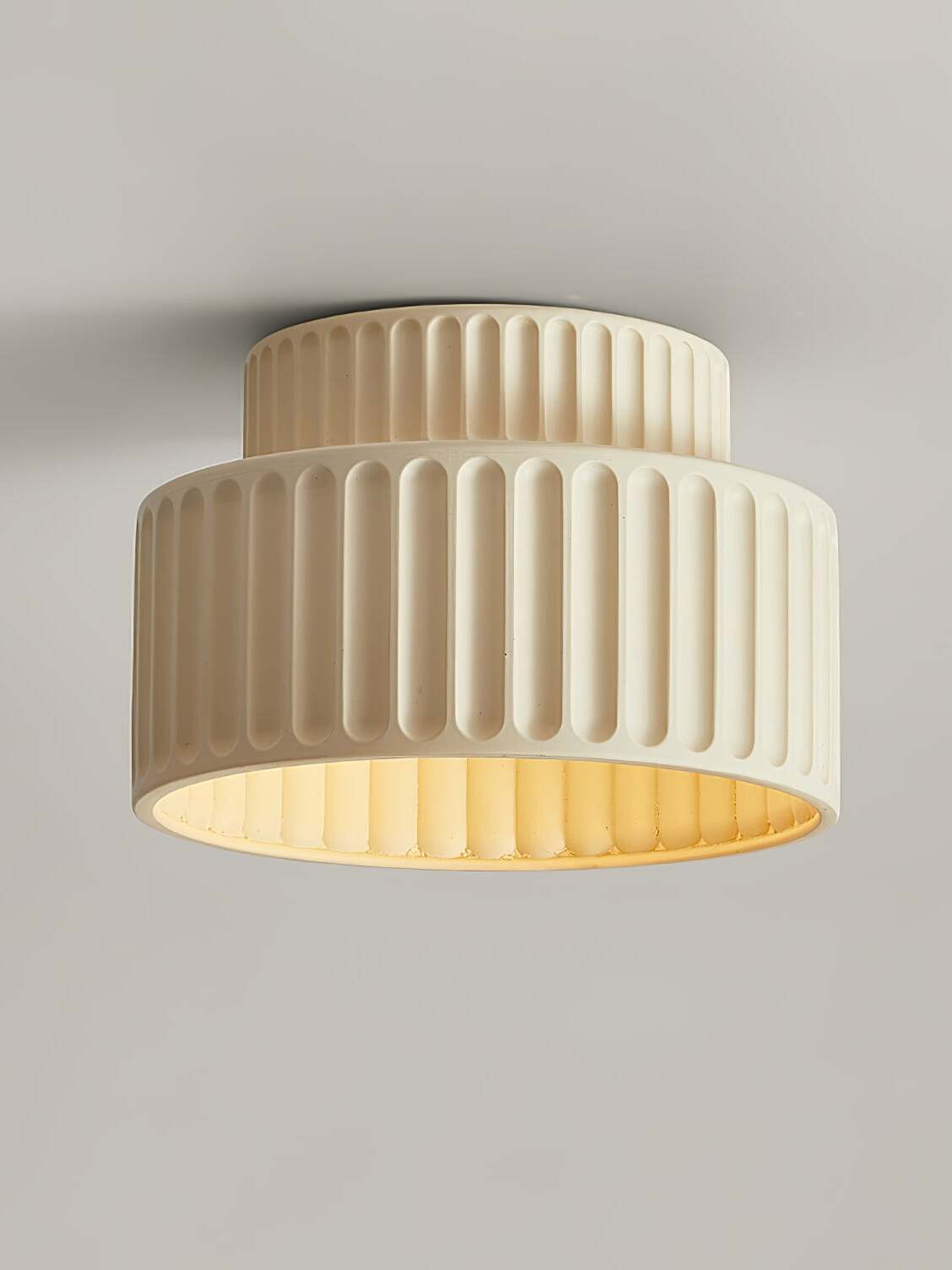 Beige grooved ceiling lamp with smaller upper tier