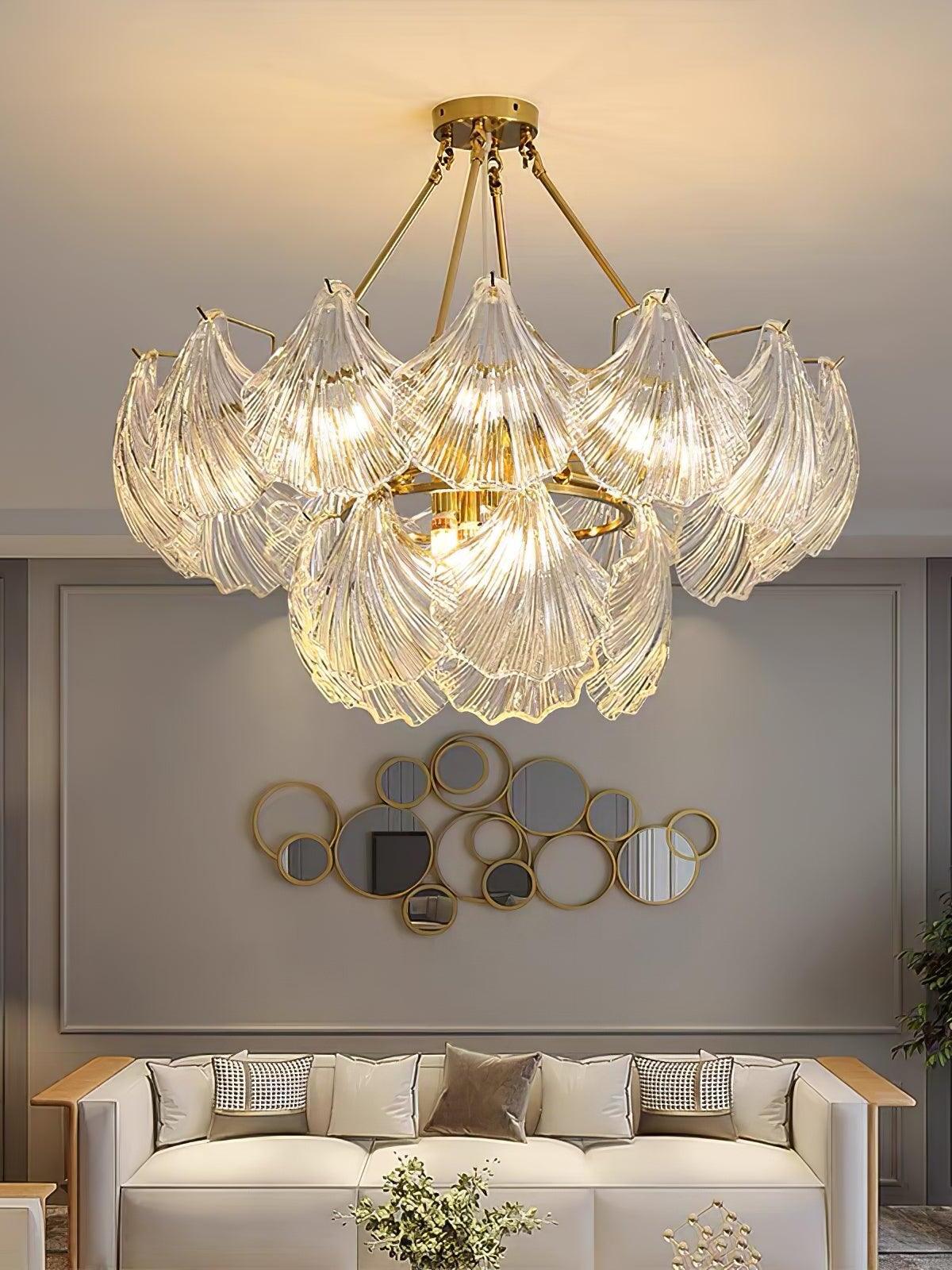 Illuminated round glass fixture above a cream sofa with round mirrors on the gray wall