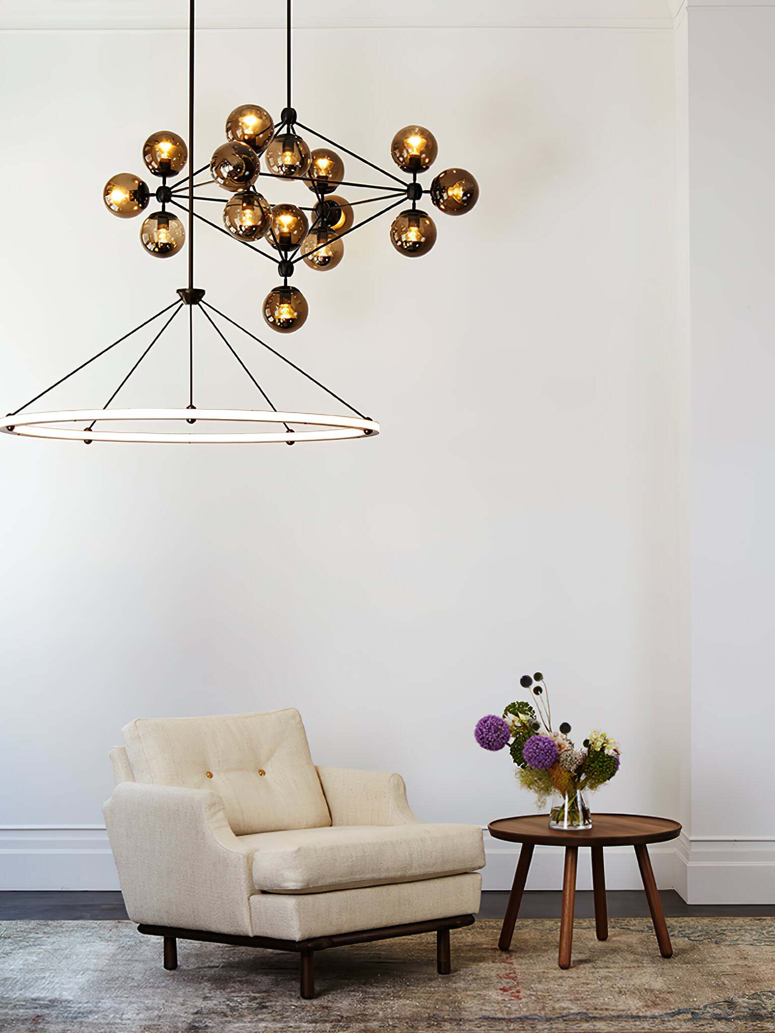 Circular pendant below a separate multi-globe ceiling light