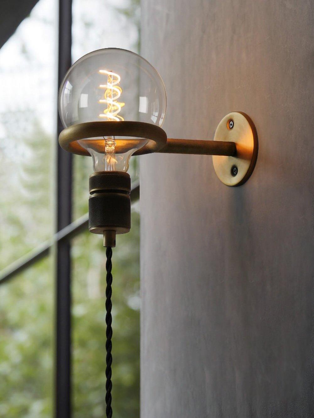 Upward-facing lit globe on ring bracket near window