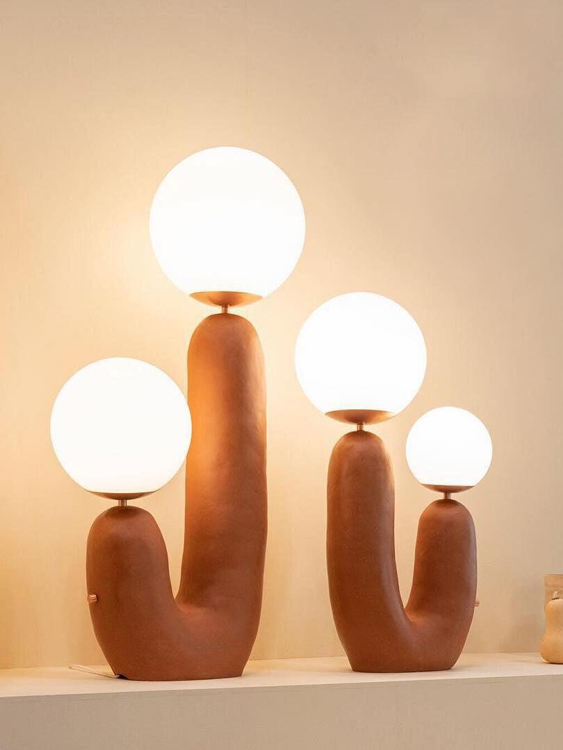 Terracotta-toned U-shaped lamps shown together